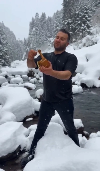 Kar ve soğuğa aldırmadı, &uuml;r&uuml;n&uuml;n&uuml; tanıtmak i&ccedil;in dereye girdi
