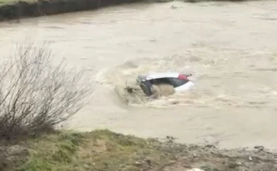 S&uuml;r&uuml;c&uuml; kıyıya &ccedil;ıktı, otomobil suda kaldı: Vatandaşlar halatla m&uuml;dahale etti
