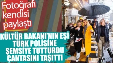 Kültür Bakanı'nın eşi Pervin Ersoy Türk polisine şemsiye tutturdu, çantasını taşıttı